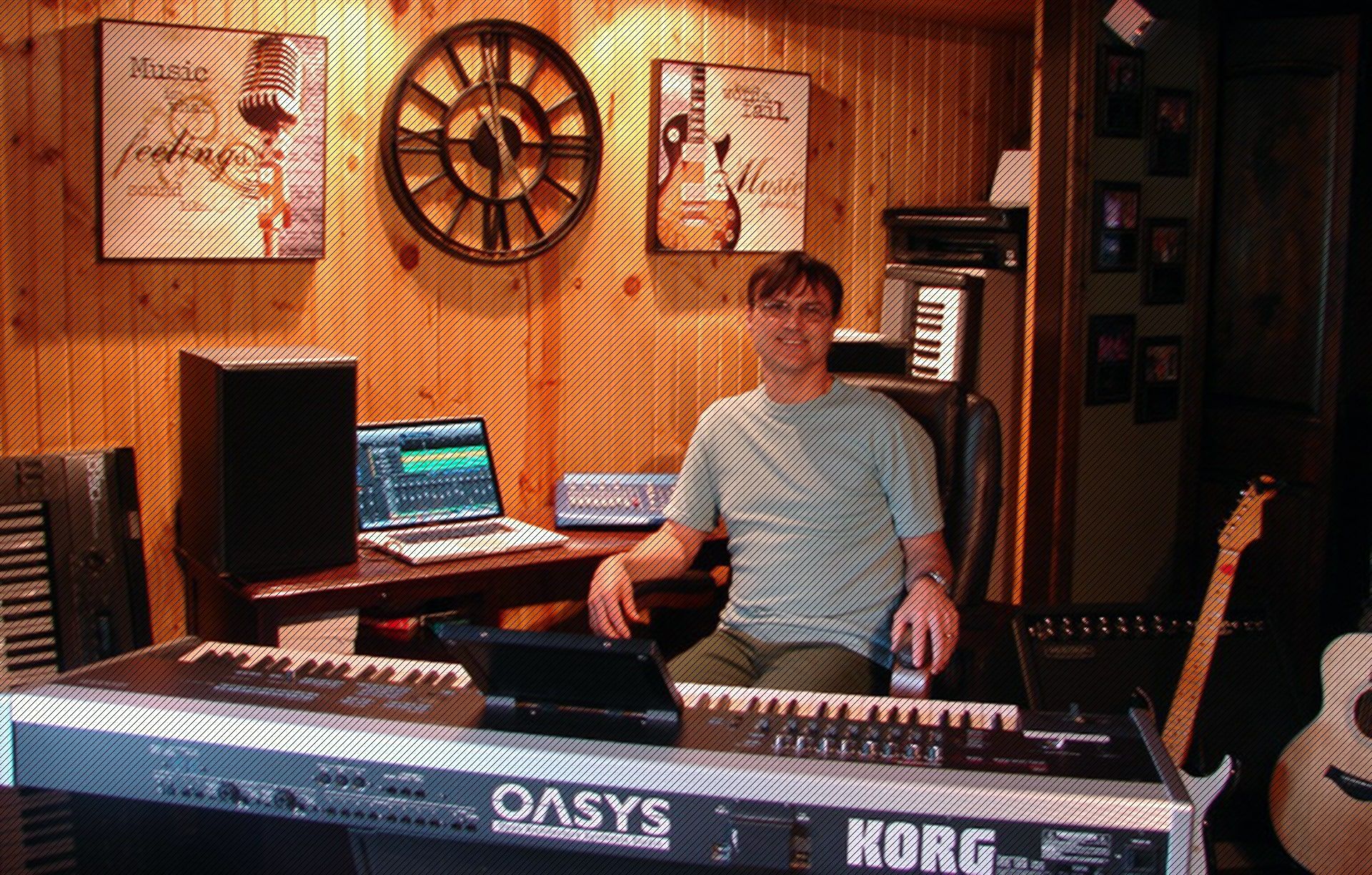 Kevin Wakefield in his home recording studio behind a Korg OASYS keyboard